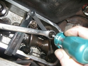 spanner holding while screwdriver adjusting the valve clearance