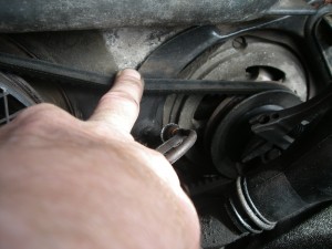 finger or thumb pressure on the fan belt to help the engine move whilst turning the spanner on the pulley nut
